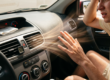 Man inside car feeling hot as warm air blows from the air conditioning vent showing 42 degrees Celsius